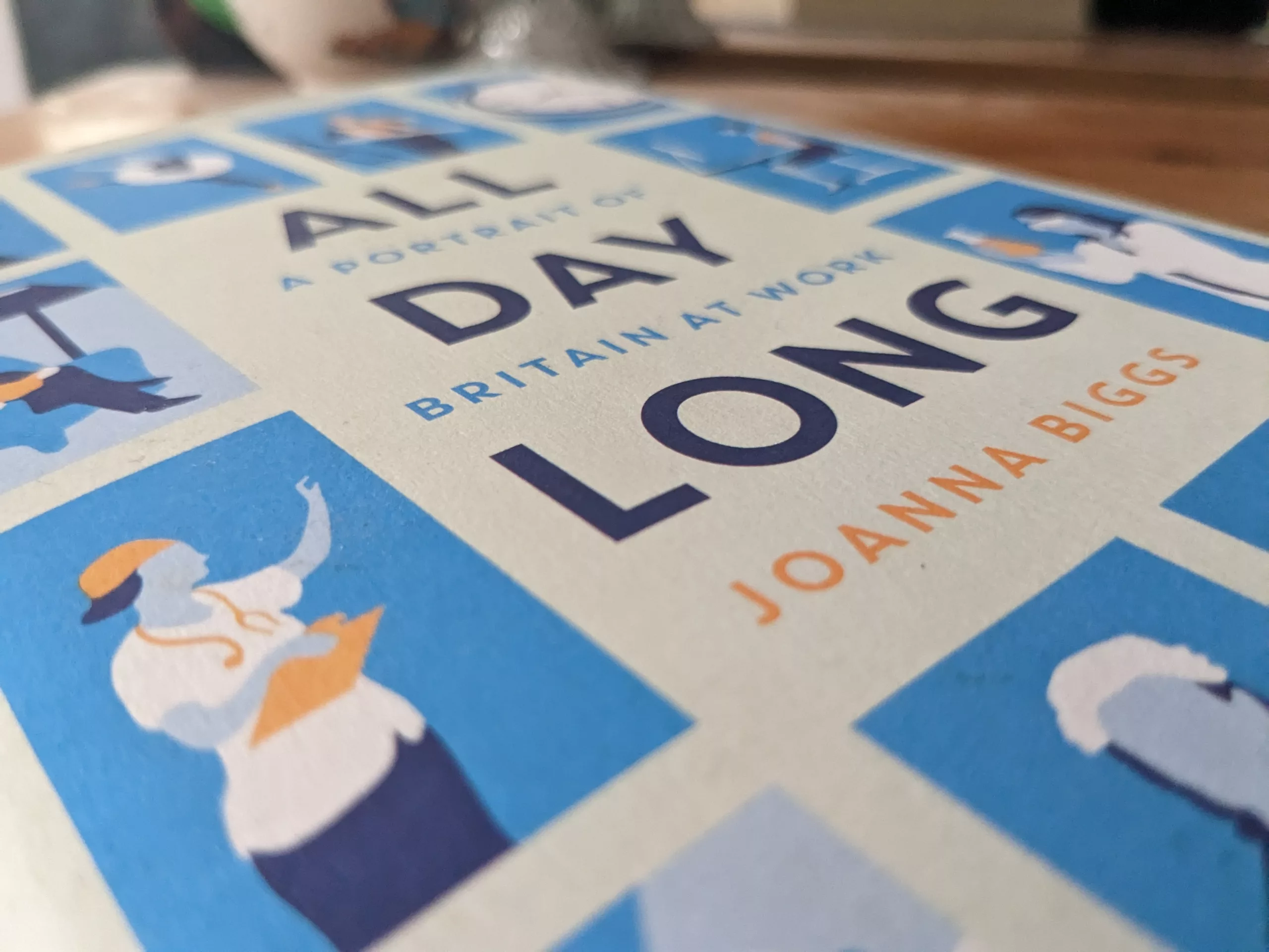 Hardback cover of 'All Day Long', showing simple five-colour illustrations of various workers.
